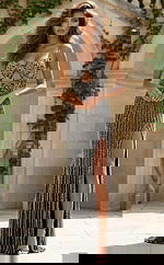 Front view of fitted embellished gown with cutout bodice, thin straps, and thigh high slit