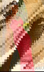 Front view of fitted embellished gown with cutout bodice, thin straps, and thigh high slit