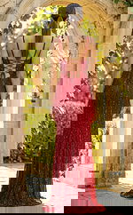 Back view of fitted embellished gown with lace up back, thin straps, and floor length silhouette