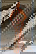 Front view of floral embellished gown with keyhole neckline and high slit