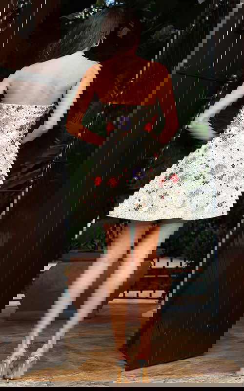 Jovani 48584 ivory multi strapless short A line dress back view showing colorful beaded floral embellishments in red, purple, teal, and pink scattered across the sequin covered skirt