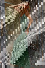 Model wearing fitted sequin evening gown with plunging neckline