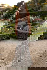 Back view of strapless mermaid gown with crystal beading and long sweep train