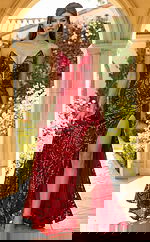 Front view of fitted sequin gown with plunging neckline, sheer inset, and thigh high slit