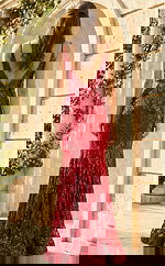 Back view of fitted sequin gown with deep V back, thin straps, and intricate leaf pattern embellishments