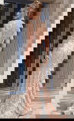 Open back sequin gown with slim silhouette and delicate floral embellishments