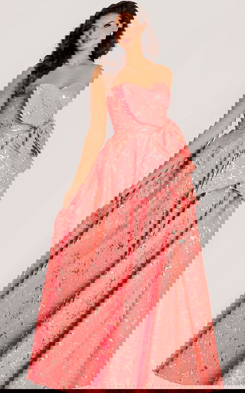 Strapless jacquard gown with metallic gold detailing, sculpted bow accent, and voluminous layered skirt.