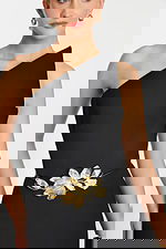 One-shoulder black jumpsuit with wide-leg pants and gold floral waist belt detail.