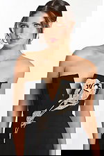 Close-up of rhinestone rose embellishment on black V-neck strapless dress