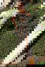 Front view of beaded gown with feather off-shoulder sleeves and corset bodice