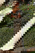 Full-length embellished gown with intricate silver beadwork design