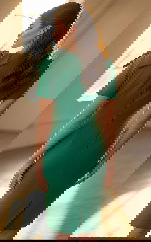 Elegant knee length fitted dress featuring structured bow accent on the shoulder