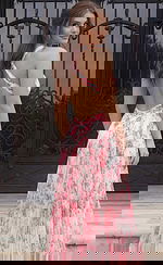 Floral pleated evening dress with open back and crossed straps flowing into a soft A line skirt