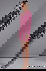 Side view of fitted metallic jacket with long sleeves and tailored silhouette