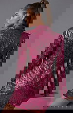 Back view of tailored metallic jacket showing textured fabric and clean seams