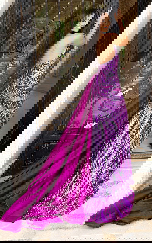 Sparkly purple sequin gown featuring open back and long train