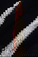 Backless gold evening dress with glittering texture and thigh-high slit