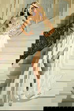 Model wearing strapless A-line gown with embellished bodice and high slit