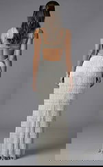 Fitted formal gown featuring intricate beadwork and high slit design