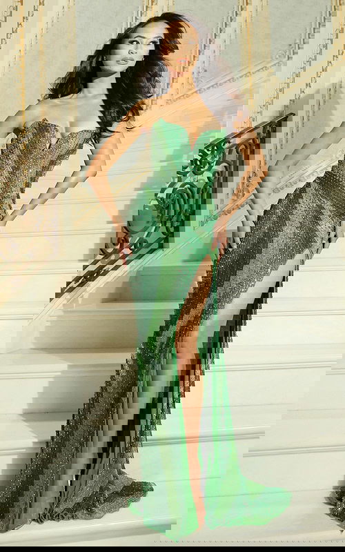 Model wearing strapless beaded gown with sweetheart neckline and high slit