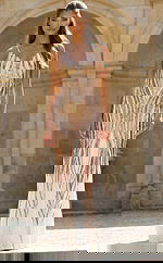 Gold and white beaded prom dress with fitted silhouette and vertical embellished pattern