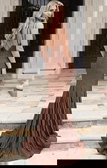 Back view of a beaded column gown with open back and flowing train