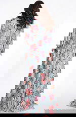 Back view of floral long sleeve chiffon gown with flowing skirt and soft drape