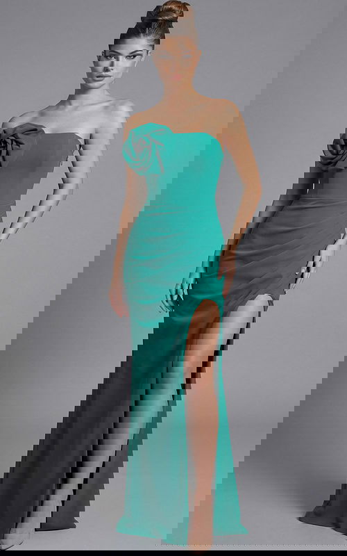 Strapless fitted evening gown with sculpted bodice, thigh high slit, and floral accent