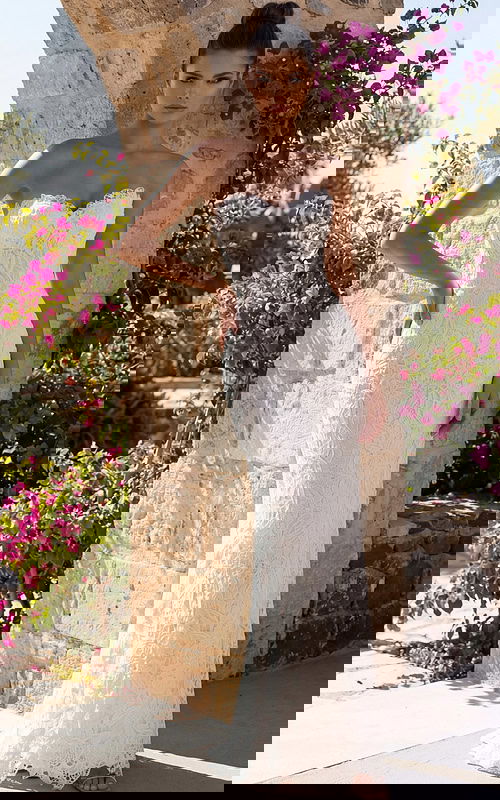 Strapless lace bridal gown with fitted column silhouette and floral texture