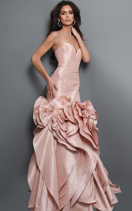 blush evening dress with a fitted bodice, flared mermaid silhouette, and dramatic layered ruffle details at the bottom