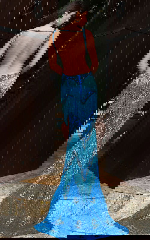 Jovani 49650 peacock blue V neck fitted prom dress with intricate crystal beading, tiered fringe detailing, and a sweep train