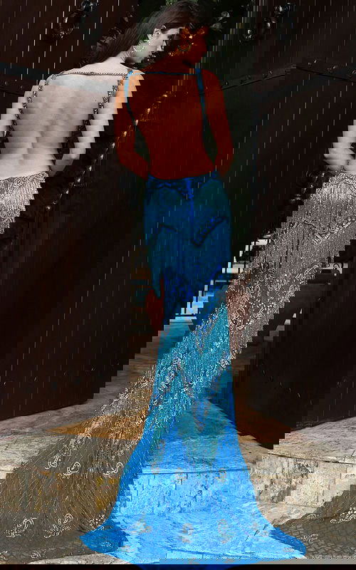 Jovani 49650 peacock blue V neck fitted prom dress with intricate crystal beading, tiered fringe detailing, and a sweep train