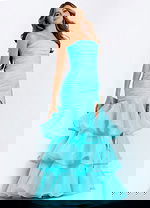 Back view of strapless formal dress with oversized bow and layered skirt.