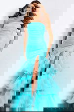 Elegant aqua evening dress featuring tiered organza ruffles and dramatic bow detail.
