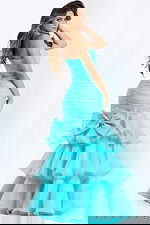 Strapless mermaid gown with ruched bodice, layered ruffle skirt, and thigh slit.