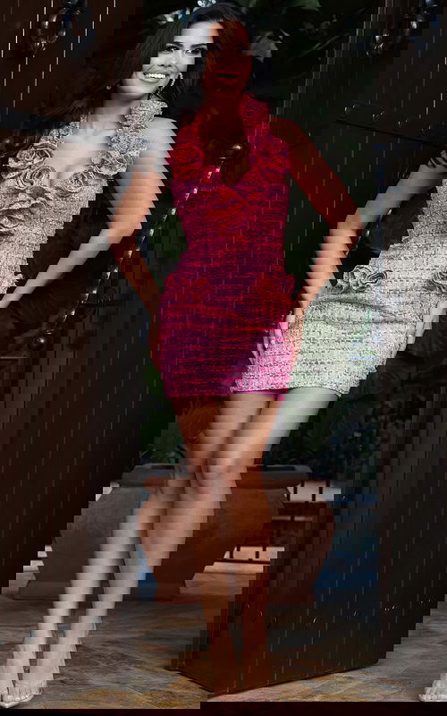 Pink textured halter mini dress with oversized rosette details and fitted silhouette