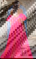 Open back strapless mini dress with voluminous ruffled sleeves and flowing overskirt