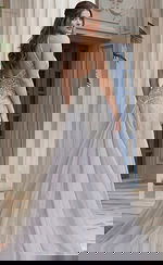 Back view of beaded halter style dress with open back, fitted waist, and flowing sheer overskir