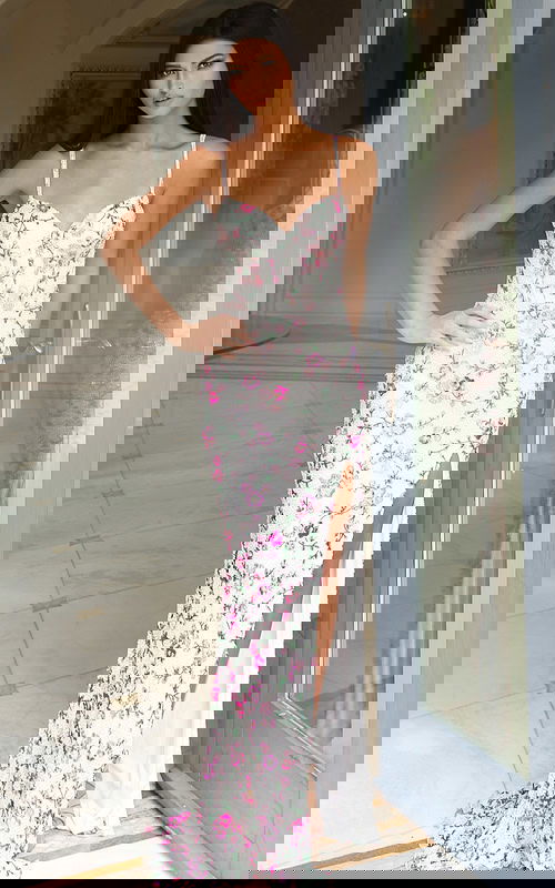 Model wearing floral embroidered gown with sweetheart neckline and slit