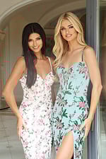 Two models in floral embellished gowns with delicate straps and fitted shape