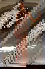 Elegant floor length gown featuring detailed beading and refined structure