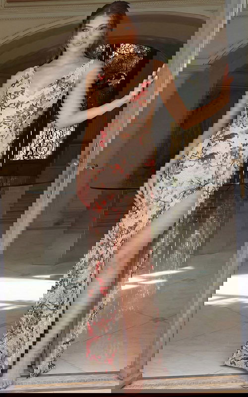 Elegant floor length gown featuring detailed beading and refined structure