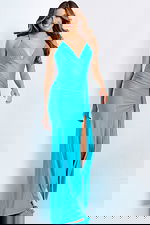 Floor-length halter-style evening dress featuring open back and side slit.