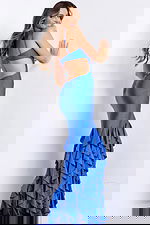 Vibrant mermaid gown with ruffled layered hem and thin straps.