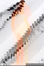 Metallic strapless gown featuring draped skirt and thigh-high slit.