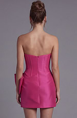 Back view of a hot pink strapless mini dress showing a fitted back with a hidden zipper closure and tailored seams.