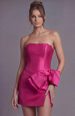 Sleek fuchsia pink satin dress with a straight-across strapless top and a voluminous bow accent.