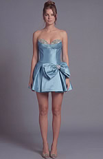 Sleek strapless cocktail dress showcasing a fitted silhouette and a voluminous flared bow detail.