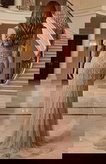 Fitted evening dress with beaded details and flowing skirt