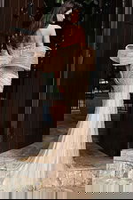 Jovani 47830 black strapless mini dress back view featuring oversized bow detail at the waist with dramatic floor length satin train